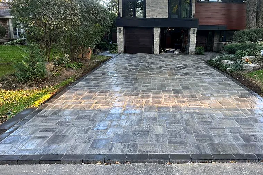 Interlock driveway in front of a modern home