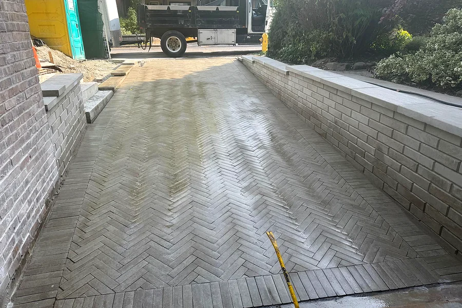 Bobby Paving crew laying a herringbone interlock driveway